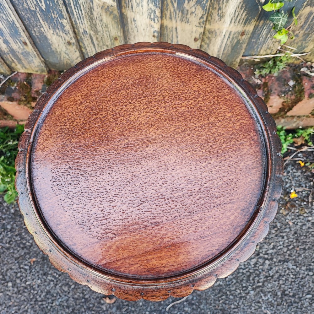 An antique mahogany wine table featuring a dished circular top, a turned cluster column stem, and three curved tripod legs. View III