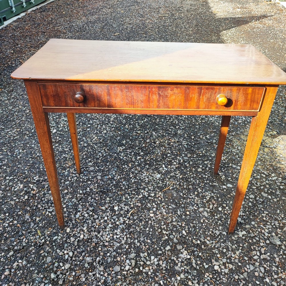 A Georgian mahogany side table with square tapered legs and an open single drawer featuring green lining paper and turned wooden knobs. View II