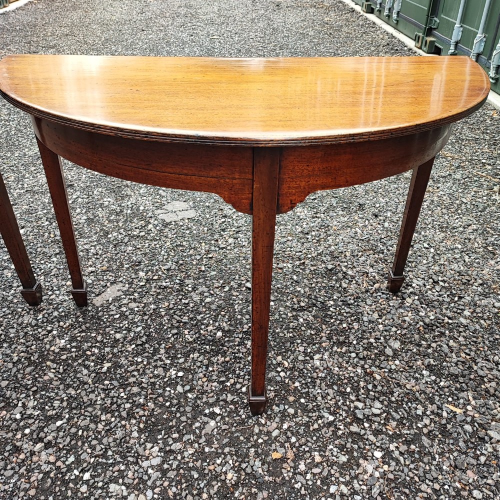 A pair of Georgian demi lune mahogany console tables View V