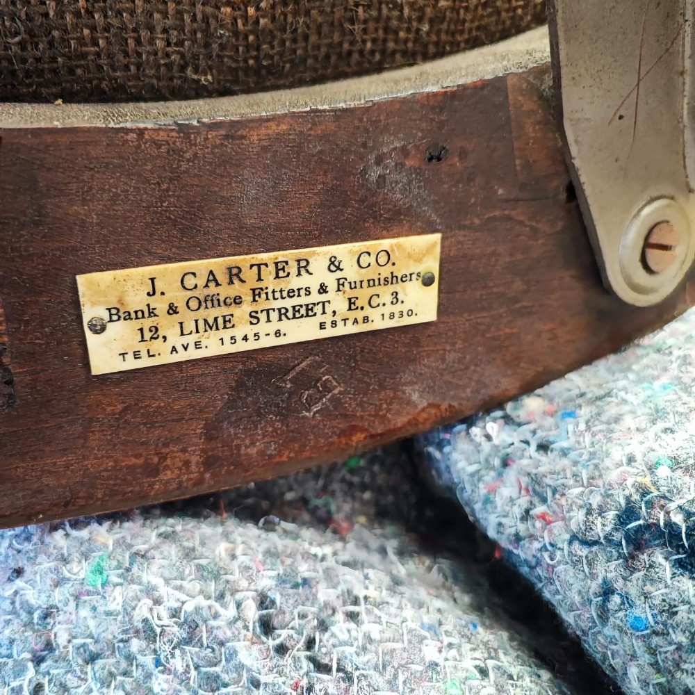 An antique mahogany revolving desk chair featuring a curved slatted back, studded leather seat, and a quadruped swivel base on castors. View VII