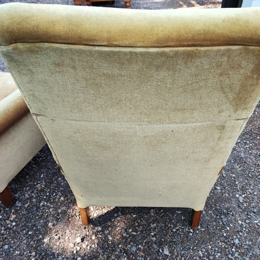 A pair of Victorian armchairs upholstered in gold velvet fabric featuring high backrests and turned walnut front legs on brass castors. View IV