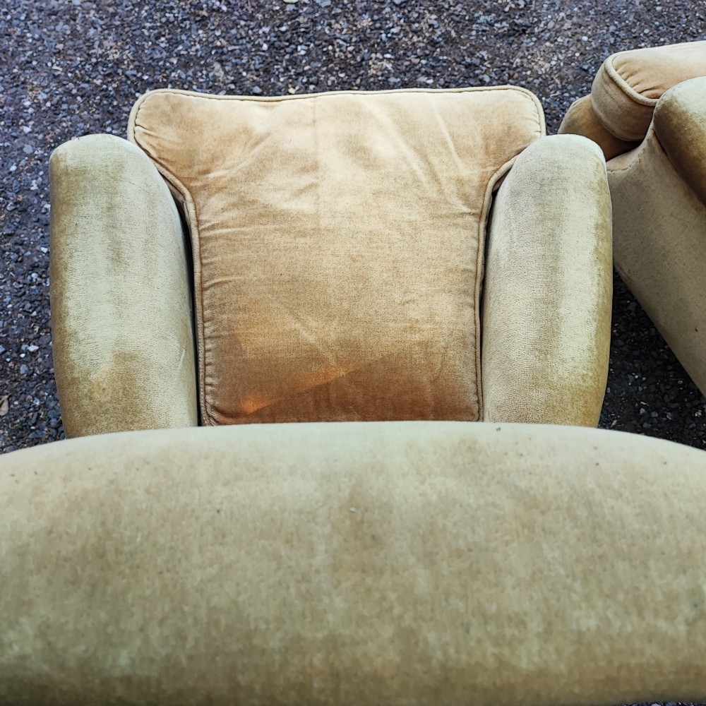 A pair of Victorian armchairs upholstered in gold velvet fabric featuring high backrests and turned walnut front legs on brass castors. View VI