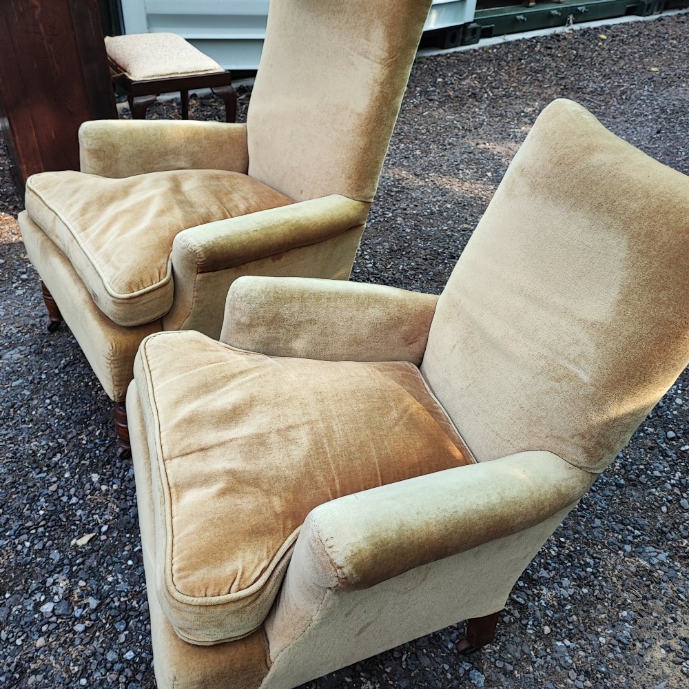 A pair of Victorian armchairs upholstered in gold velvet fabric featuring high backrests and turned walnut front legs on brass castors. View VII