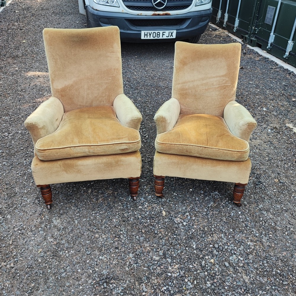 A pair of Victorian armchairs upholstered in gold velvet fabric featuring high backrests and turned walnut front legs on brass castors. View VIII