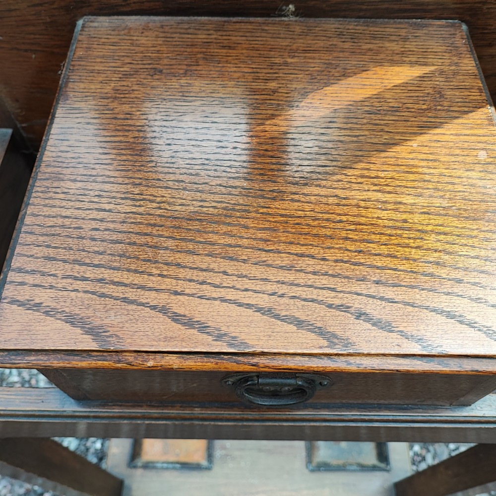 A tall Victorian oak hallstand featuring an upper mirror panel, coat hooks, a central glove drawer, and a lower stick stand with metal drip trays. View II