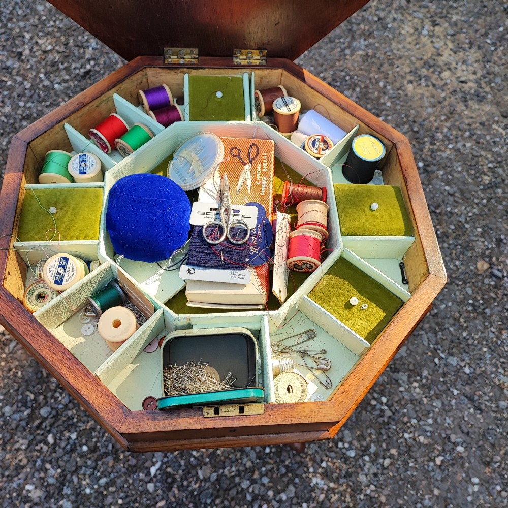 A Victorian walnut trumpet work box featuring an octagonal hinged top, tapering conical body, and carved tripod cabriole legs. View II
