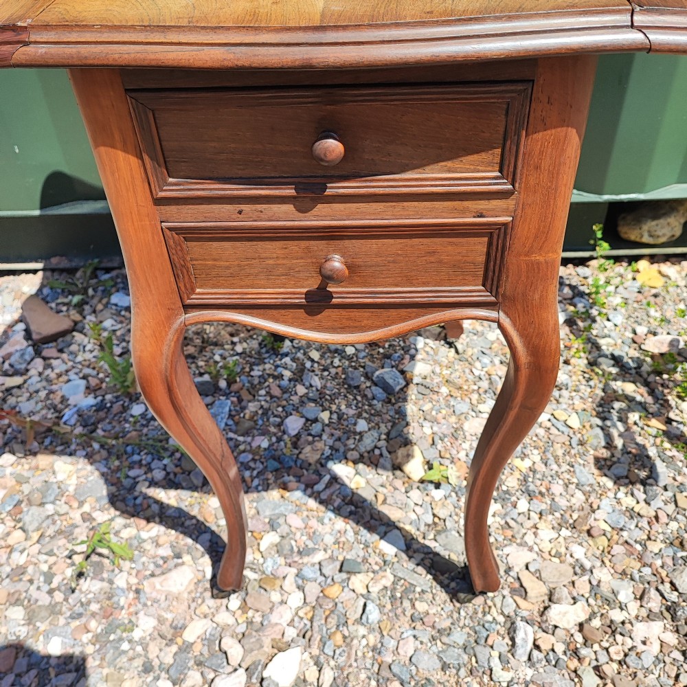 An antique rosewood drop leaf bedside table featuring cabriole legs and two front drawers with small wooden knobs. View IV