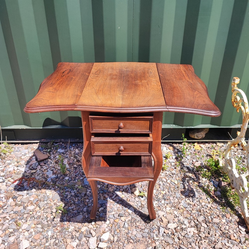 An antique rosewood drop leaf bedside table featuring cabriole legs and two front drawers with small wooden knobs. View VIII