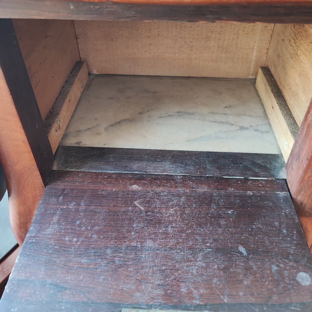 An antique rosewood drop leaf bedside table featuring cabriole legs and two front drawers with small wooden knobs. View X