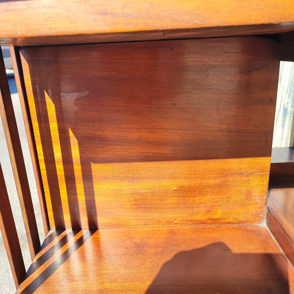 An Edwardian inlaid mahogany revolving bookcase featuring a square top with a central starburst patera inlay, three small drawers with brass ring handles, and vertical timber side slats. View III