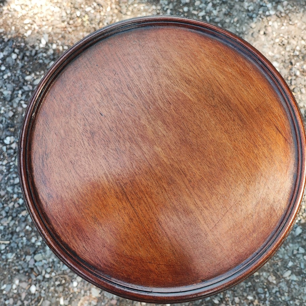 A small Edwardian mahogany wine table featuring a circular dished top supported by a turned stem and tripod legs. View III