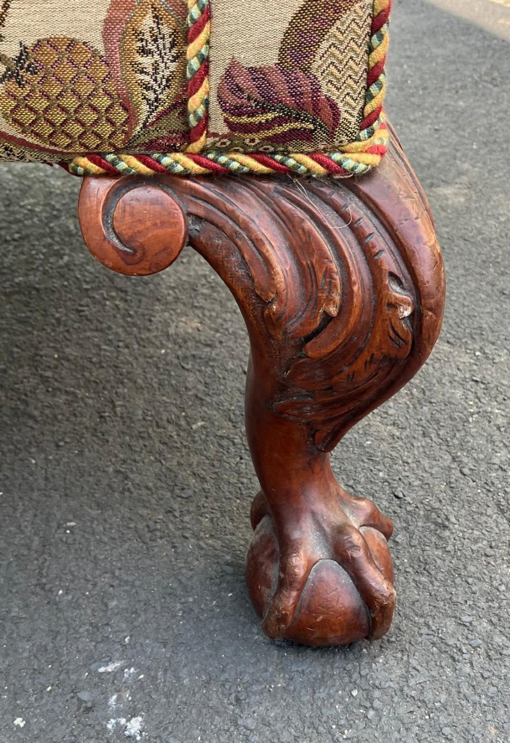 A high-back wing chair featuring floral tapestry upholstery, rolled arms, braided edge trim, and carved mahogany cabriole front legs with ball and claw feet. View II