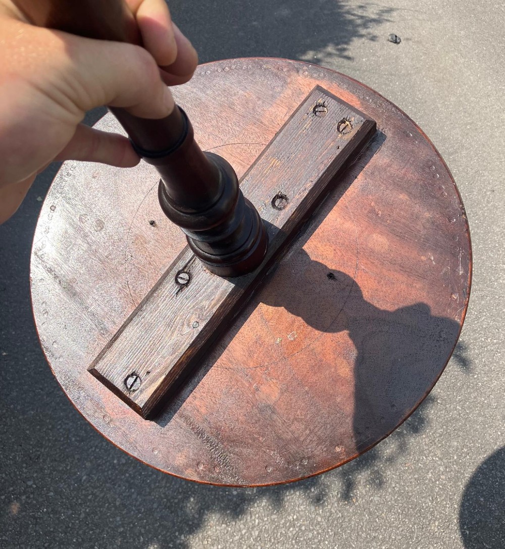 A circular mahogany wine table featuring a turned central column and a tripod base. View II