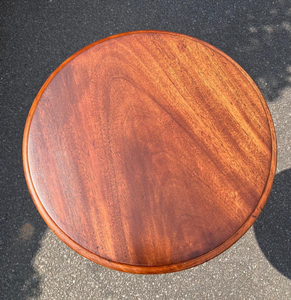 A circular mahogany wine table featuring a turned central column and a tripod base. View IV
