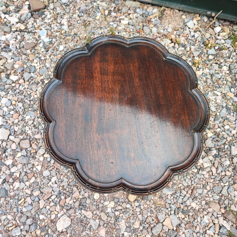 A dark mahogany tripod wine table featuring a scalloped rim top, turned central column, and three cabriole legs. View II