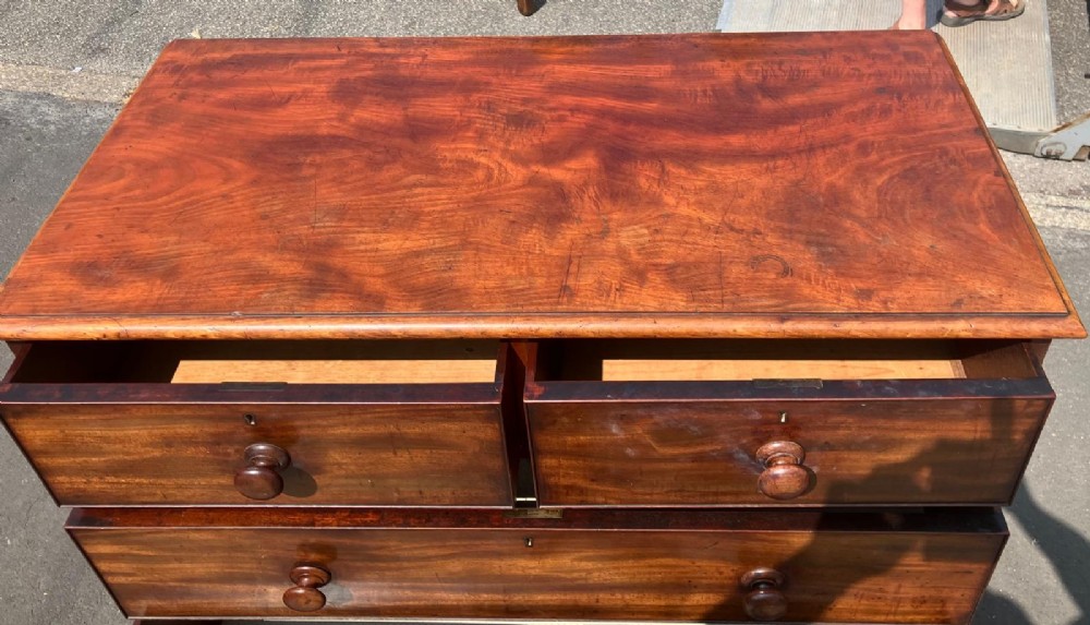 A Victorian flame mahogany chest of drawers featuring a two-over-three drawer configuration, turned wooden knobs, and a solid plinth base. View III