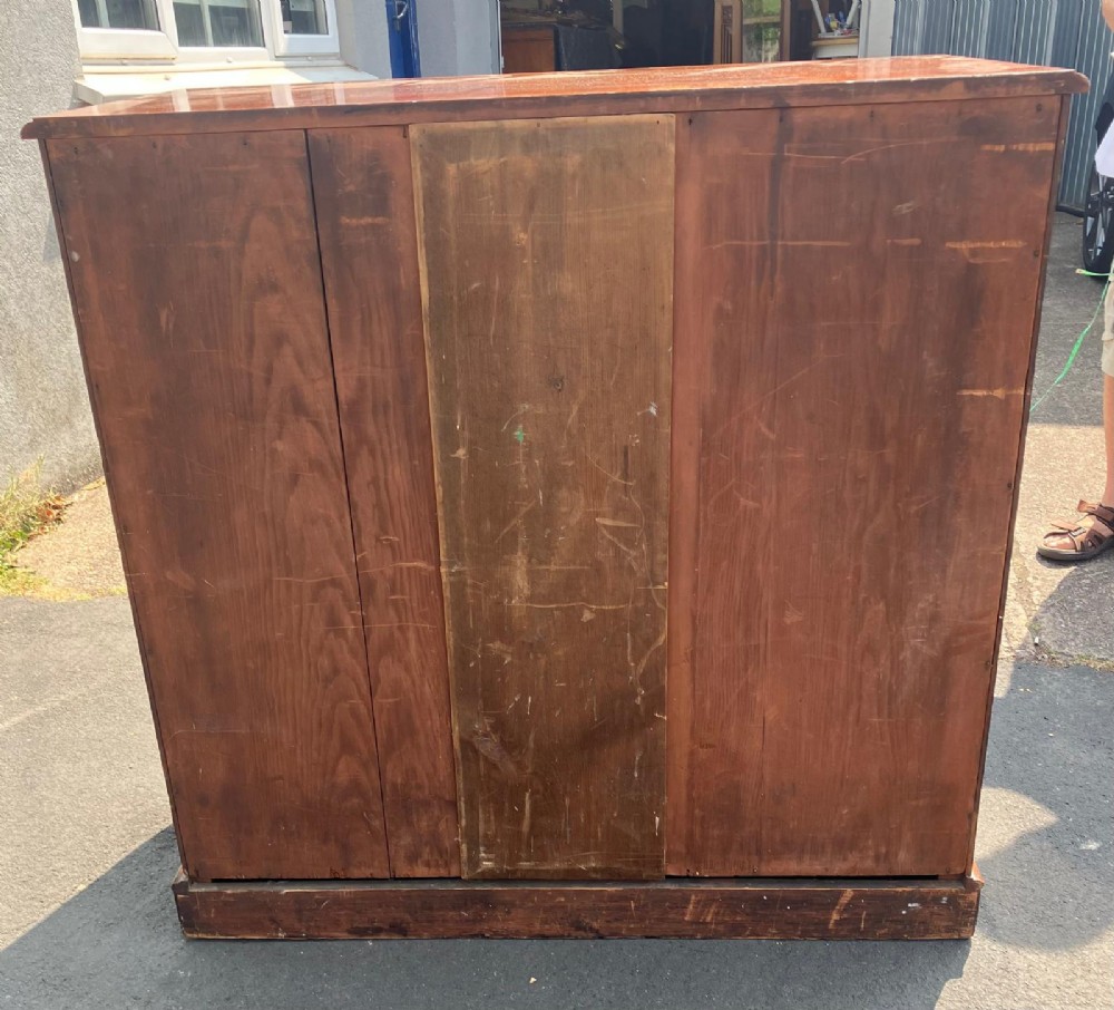 A Victorian flame mahogany chest of drawers featuring a two-over-three drawer configuration, turned wooden knobs, and a solid plinth base. View IV