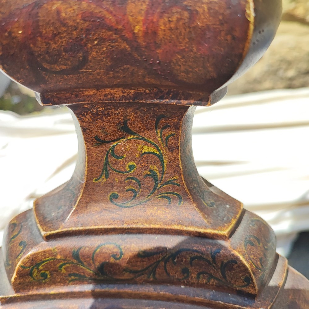 A dark carved wooden standard lamp featuring a baluster column and topped with a cream fabric lampshade trimmed with fringe. View III