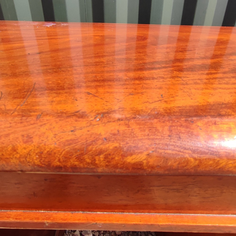 An antique mahogany pedestal desk featuring eight drawers with turned wooden knobs and a polished rectangular top surface. View II