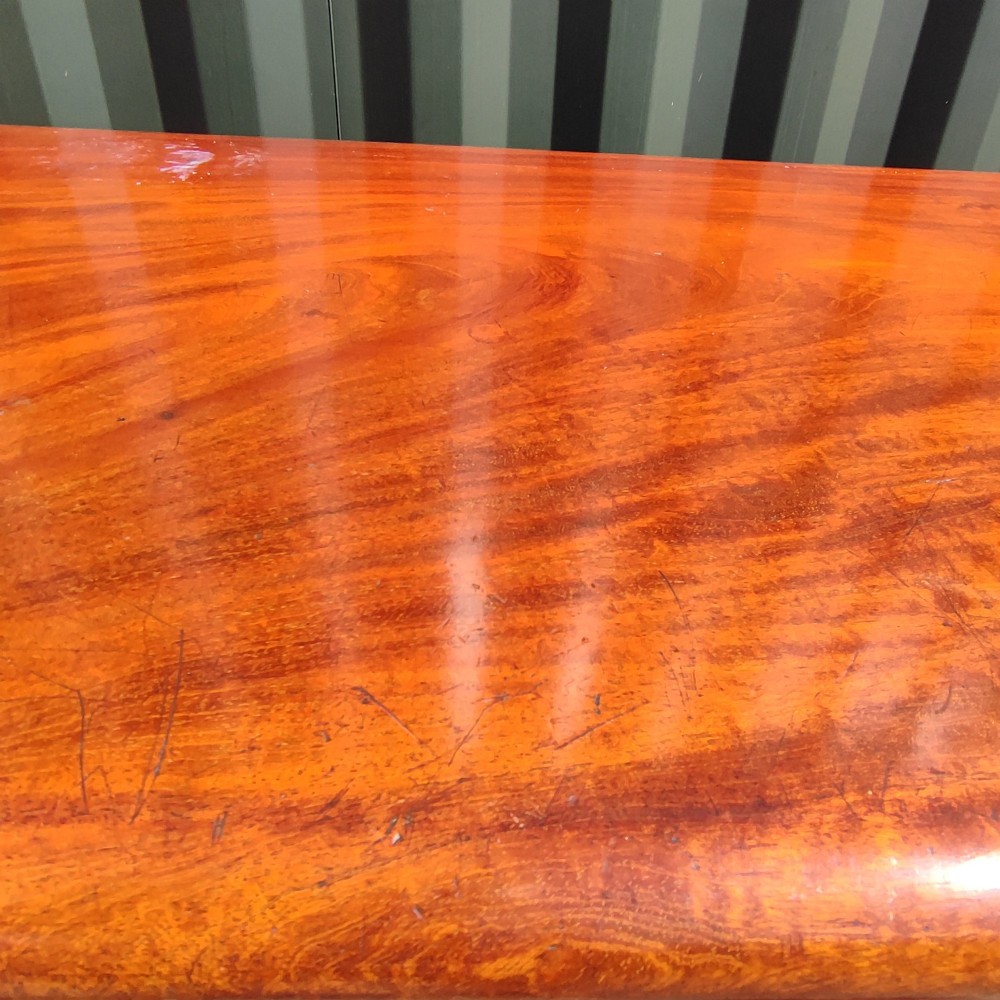 An antique mahogany pedestal desk featuring eight drawers with turned wooden knobs and a polished rectangular top surface. View III