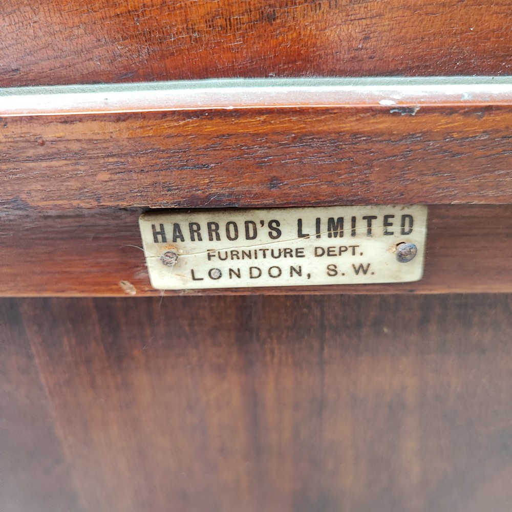 A narrow Victorian mahogany standing dressing table featuring an integrated swivel mirror above a single drawer, storage cupboard, and curved legs. View IV