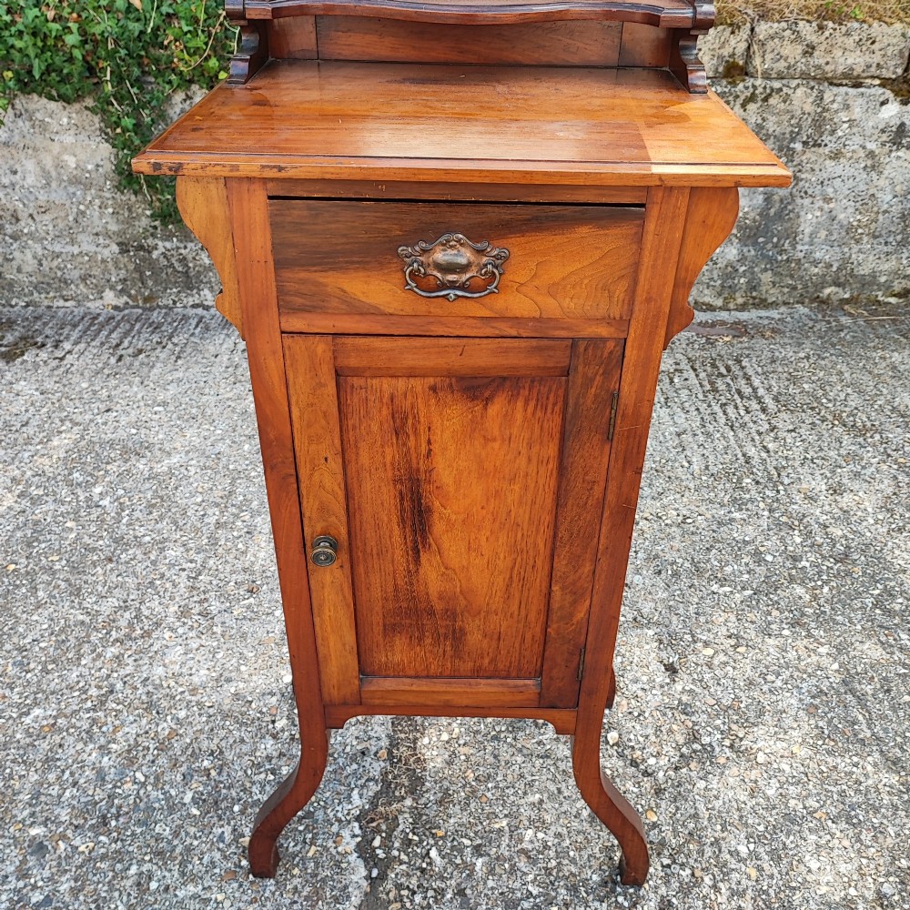 A narrow Victorian mahogany standing dressing table featuring an integrated swivel mirror above a single drawer, storage cupboard, and curved legs. View VIII