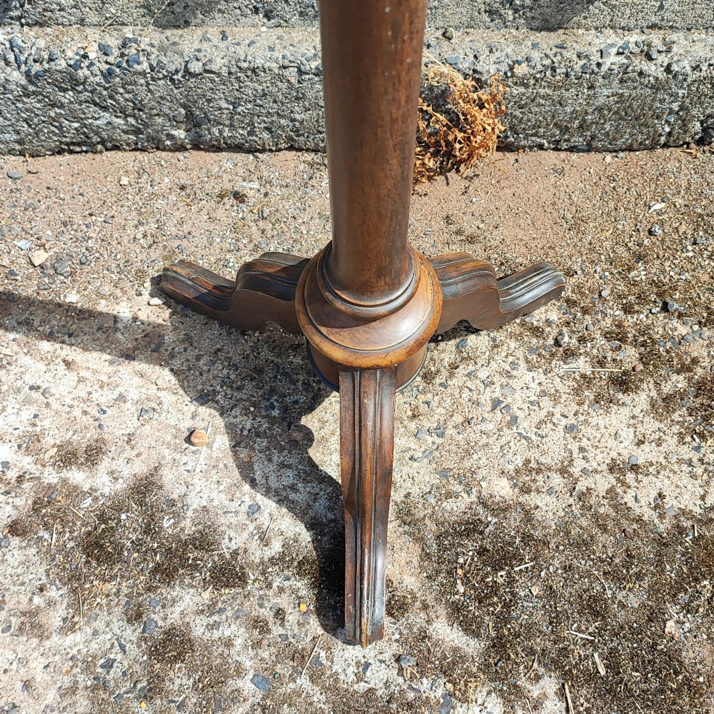 A Victorian walnut music stand featuring a fretwork lyre rest, height-adjustable brass stem, turned column, and carved tripod legs. View V