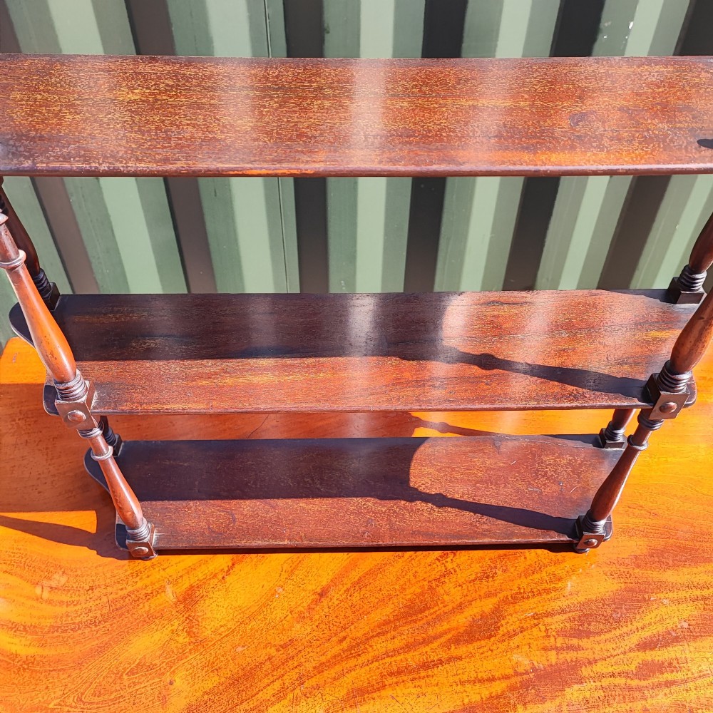 An antique Regency mahogany three-tier hanging shelf with turned spindles and finials. View II