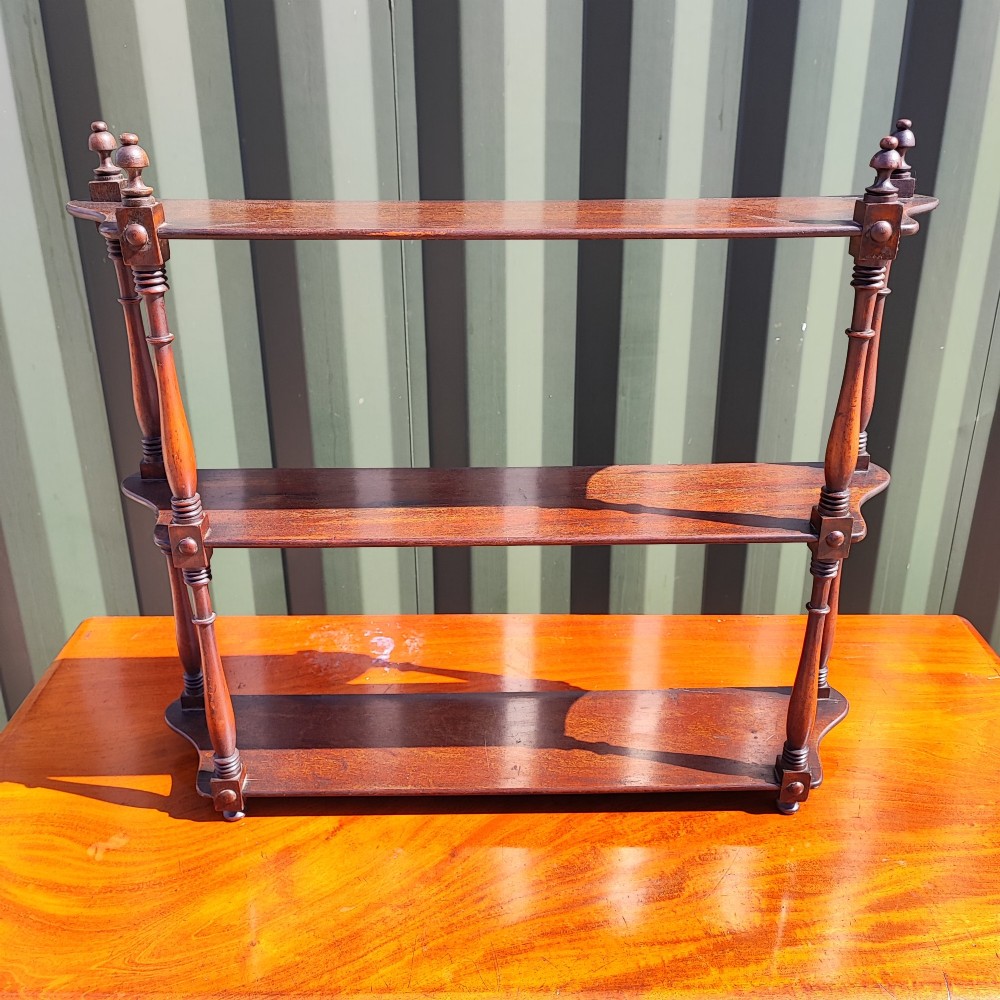 An antique Regency mahogany three-tier hanging shelf with turned spindles and finials. View IV