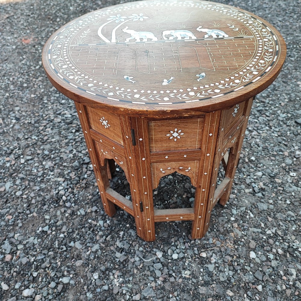 An octagonal Anglo-Indian hardwood occasional table featuring white bone inlay depicting elephants, palm trees, and floral borders. View II