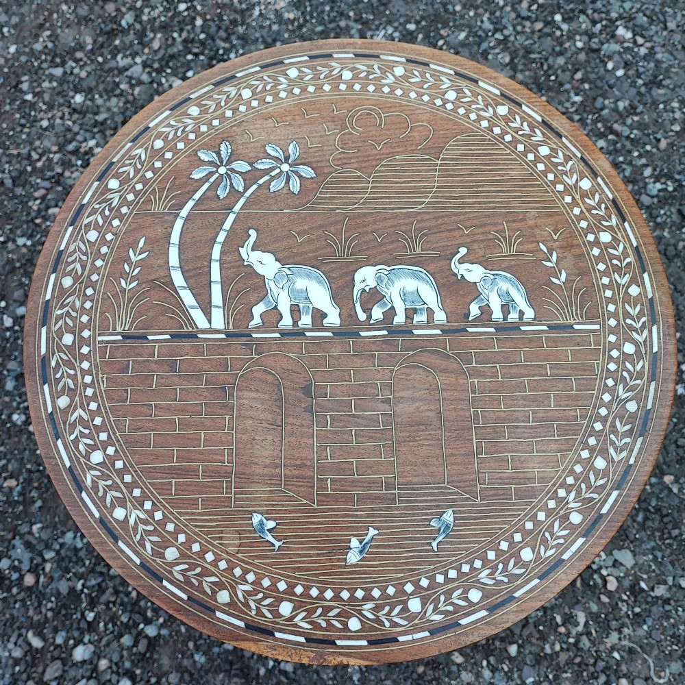 An octagonal Anglo-Indian hardwood occasional table featuring white bone inlay depicting elephants, palm trees, and floral borders. View III