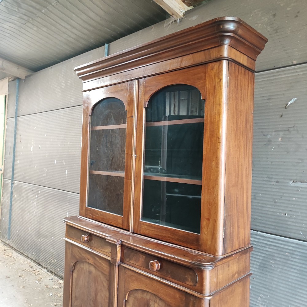 A tall Victorian mahogany bookcase featuring two glazed upper doors, two frieze drawers, and a double-door lower cupboard. View VII