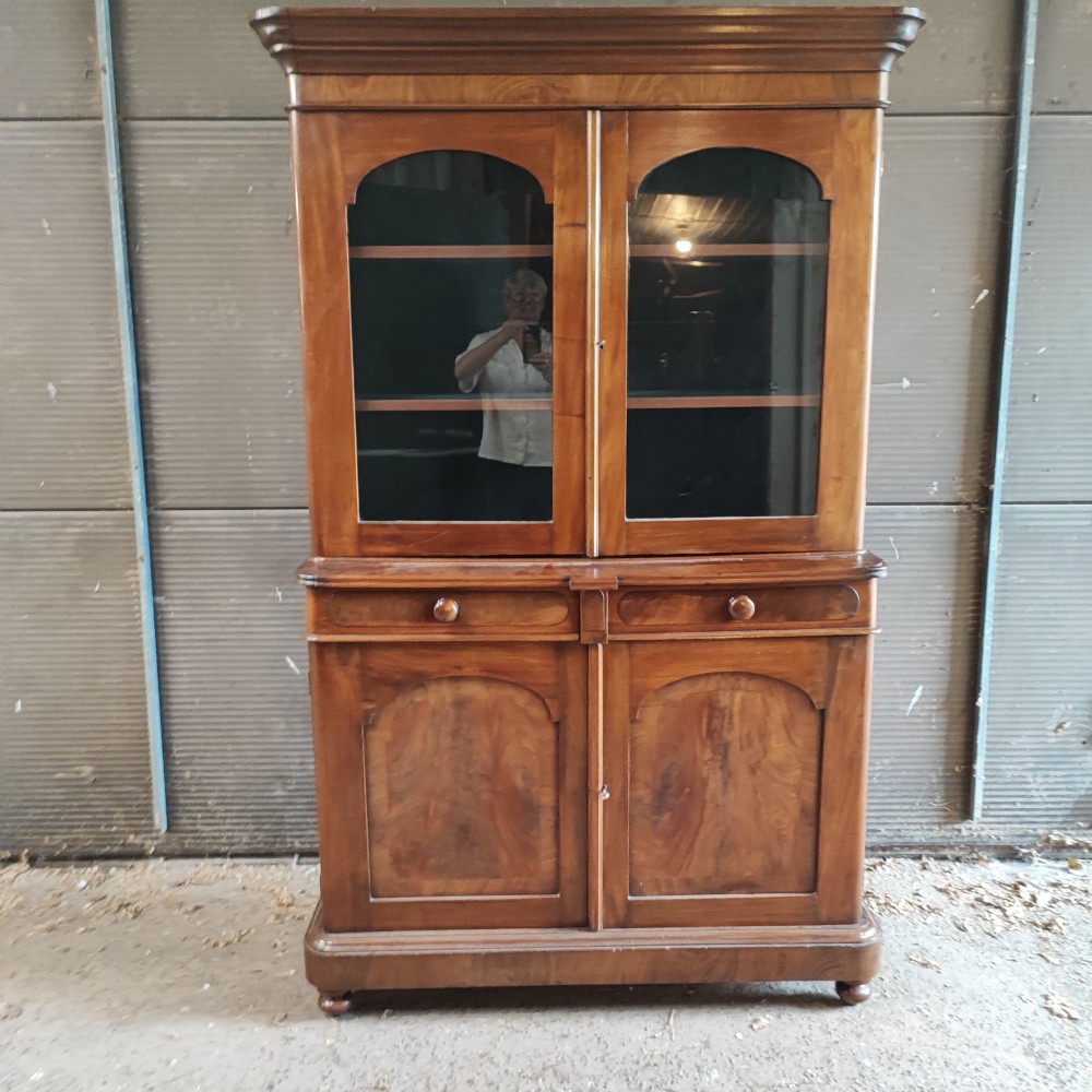 A tall Victorian mahogany bookcase featuring two glazed upper doors, two frieze drawers, and a double-door lower cupboard. View VIII