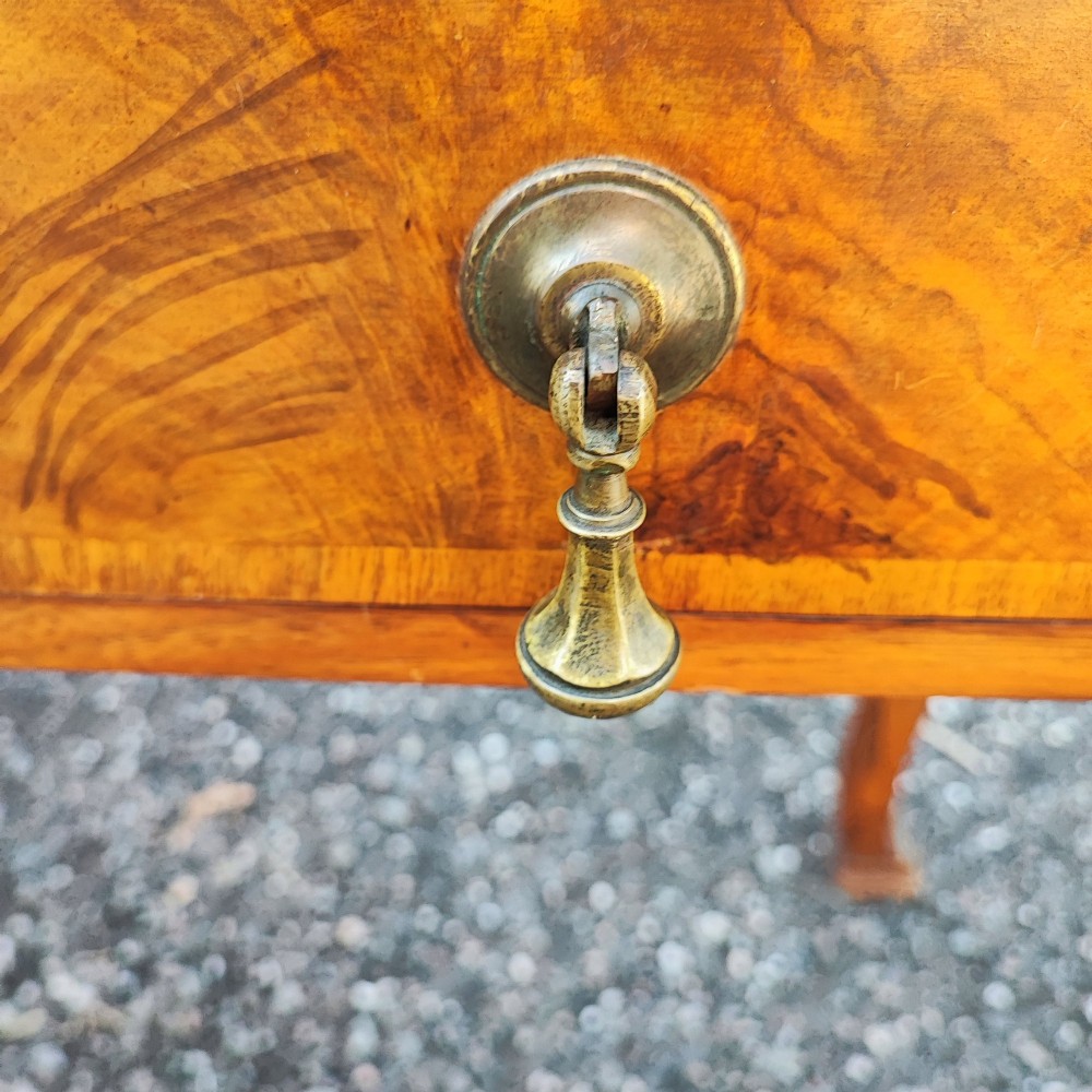 An antique walnut side serving table with two drawers, brass drop handles, cabriole legs, and a shaped decorative gallery back. View III