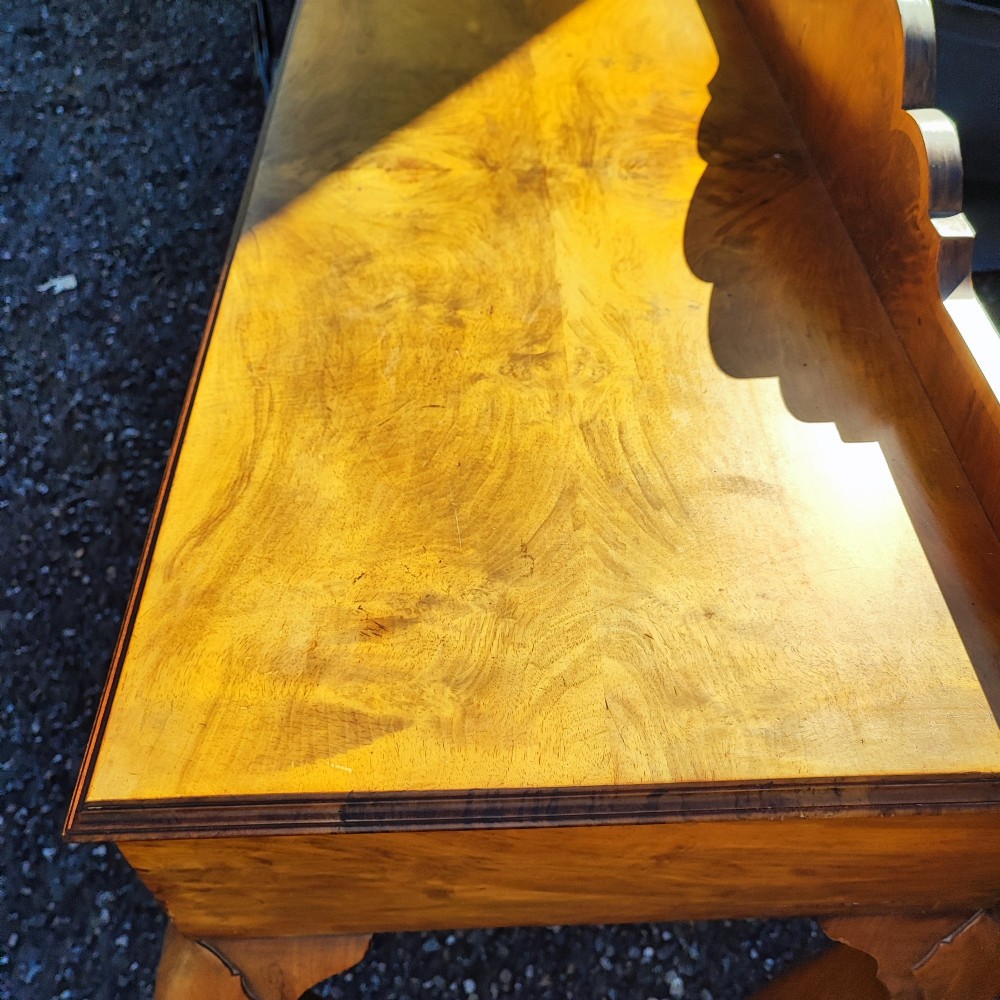 An antique walnut side serving table with two drawers, brass drop handles, cabriole legs, and a shaped decorative gallery back. View IV