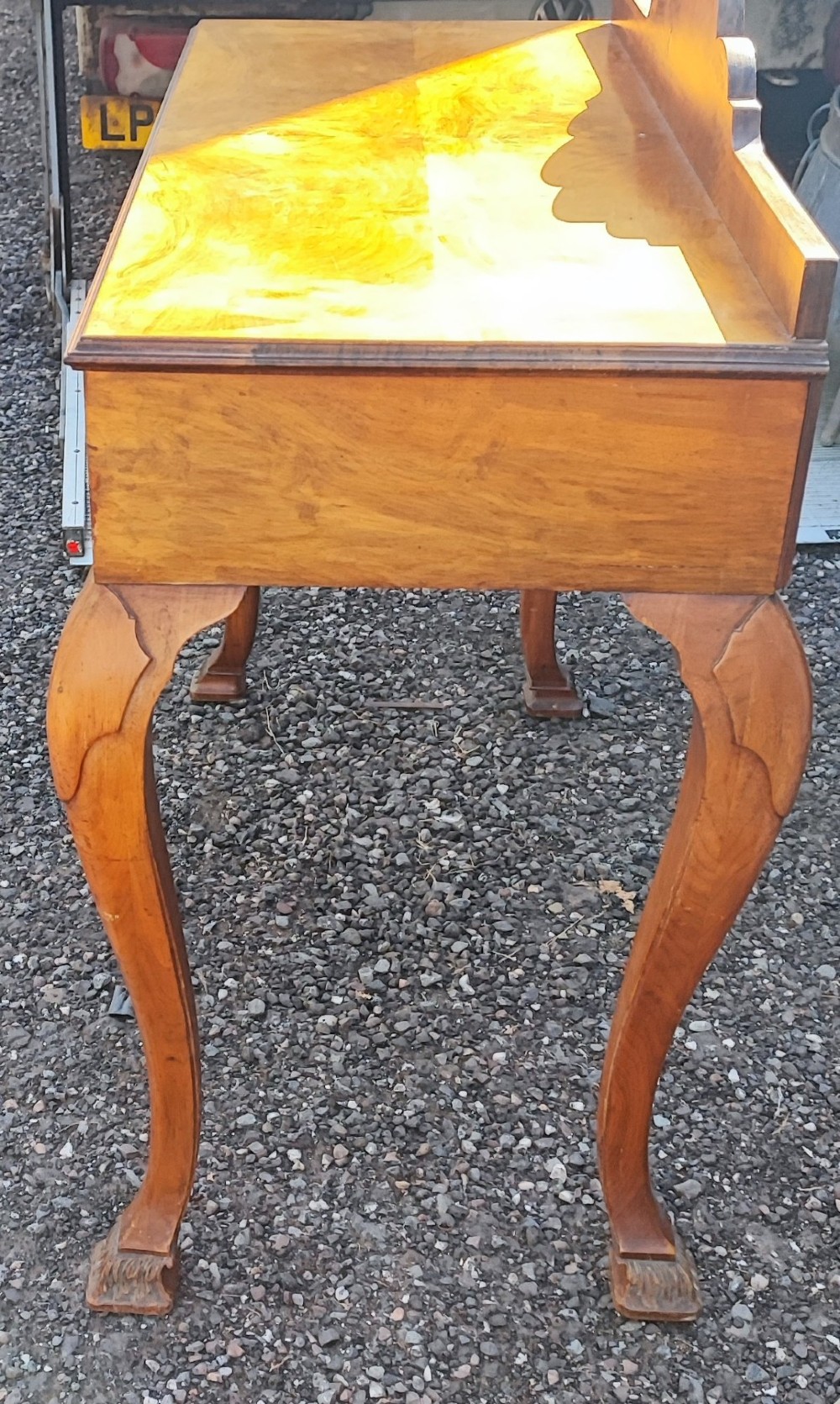 An antique walnut side serving table with two drawers, brass drop handles, cabriole legs, and a shaped decorative gallery back. View V
