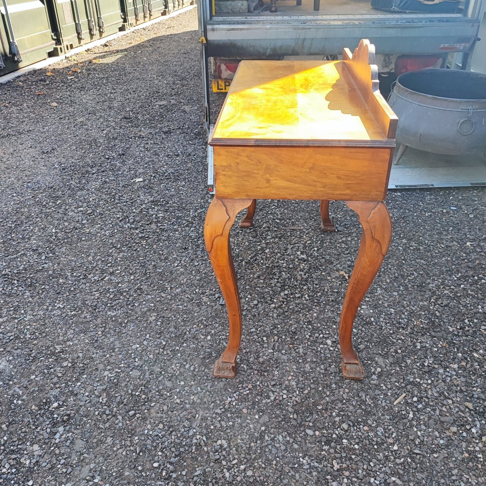 An antique walnut side serving table with two drawers, brass drop handles, cabriole legs, and a shaped decorative gallery back. View VI