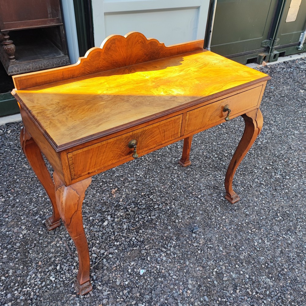 An antique walnut side serving table with two drawers, brass drop handles, cabriole legs, and a shaped decorative gallery back. View VIII