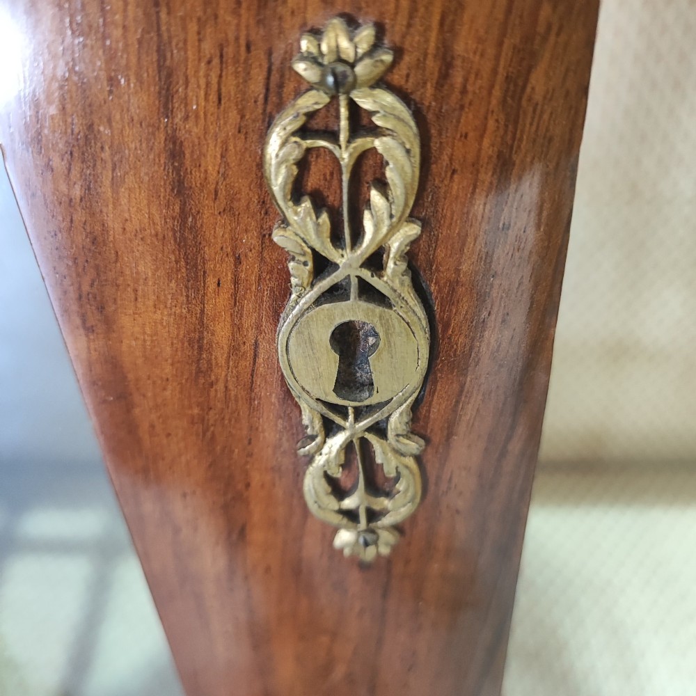 A tall 19th-century walnut display cabinet featuring two glazed doors with Gothic arched tracery above solid figured wood lower panels. View III