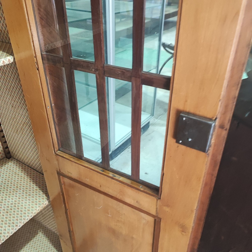 A tall 19th-century walnut display cabinet featuring two glazed doors with Gothic arched tracery above solid figured wood lower panels. View V