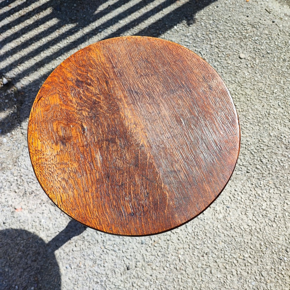 A Georgian solid oak wine table featuring a circular top, turned central pedestal, and three splayed tripod legs. View III