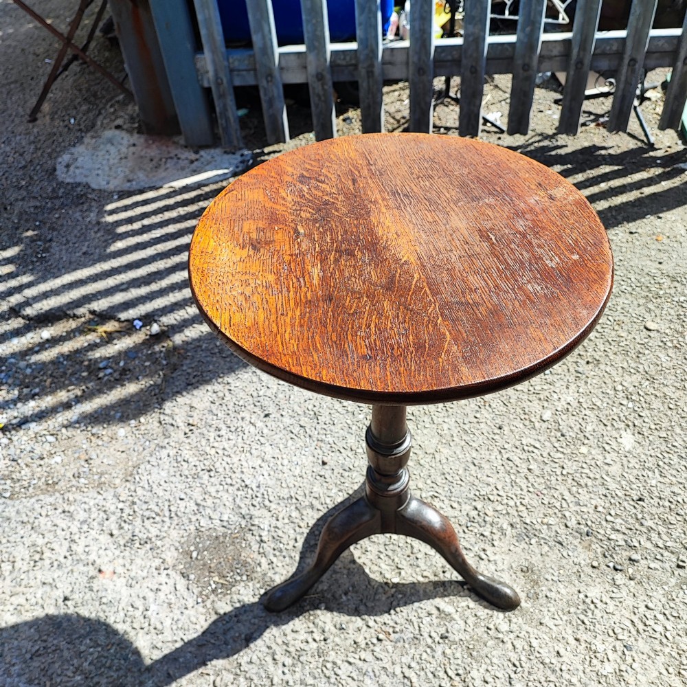 A Georgian solid oak wine table featuring a circular top, turned central pedestal, and three splayed tripod legs. View IV