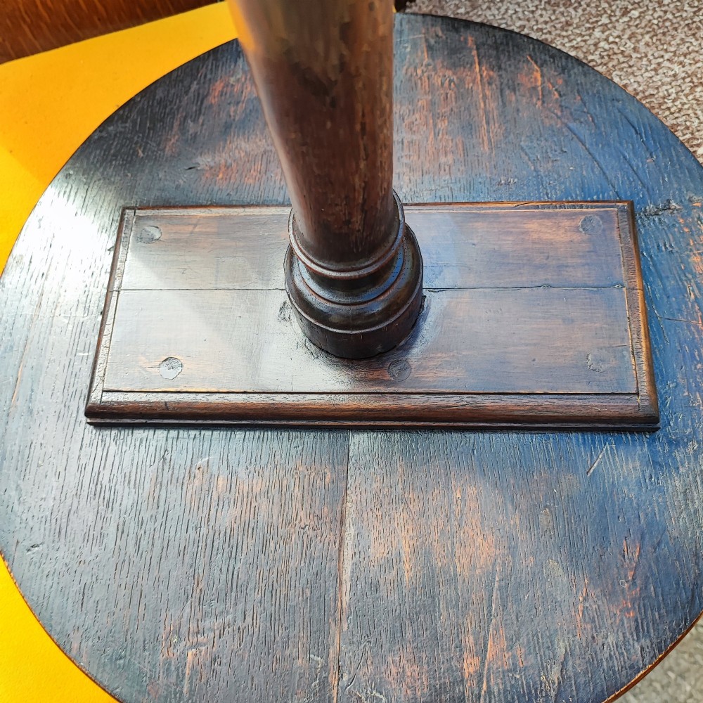 A Georgian solid oak wine table featuring a circular top, turned central pedestal, and three splayed tripod legs. View VI