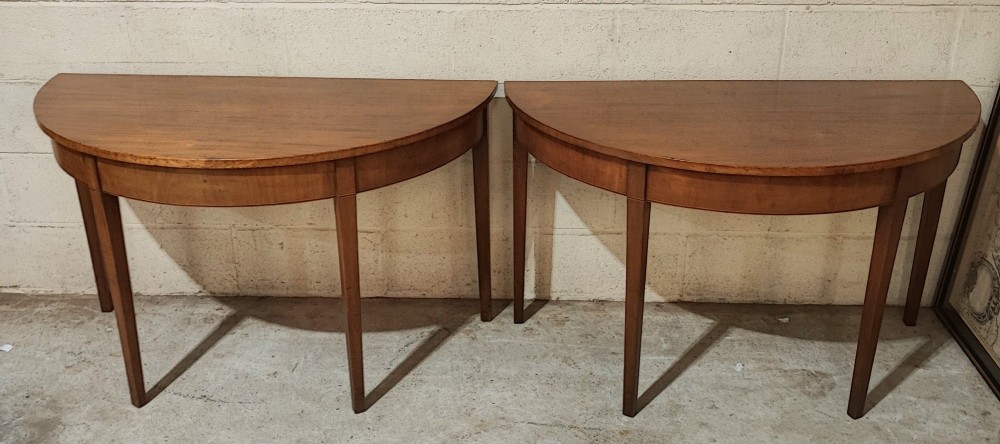 A pair of antique Georgian mahogany demi-lune console tables featuring semi-circular tops and straight tapered legs. View VI