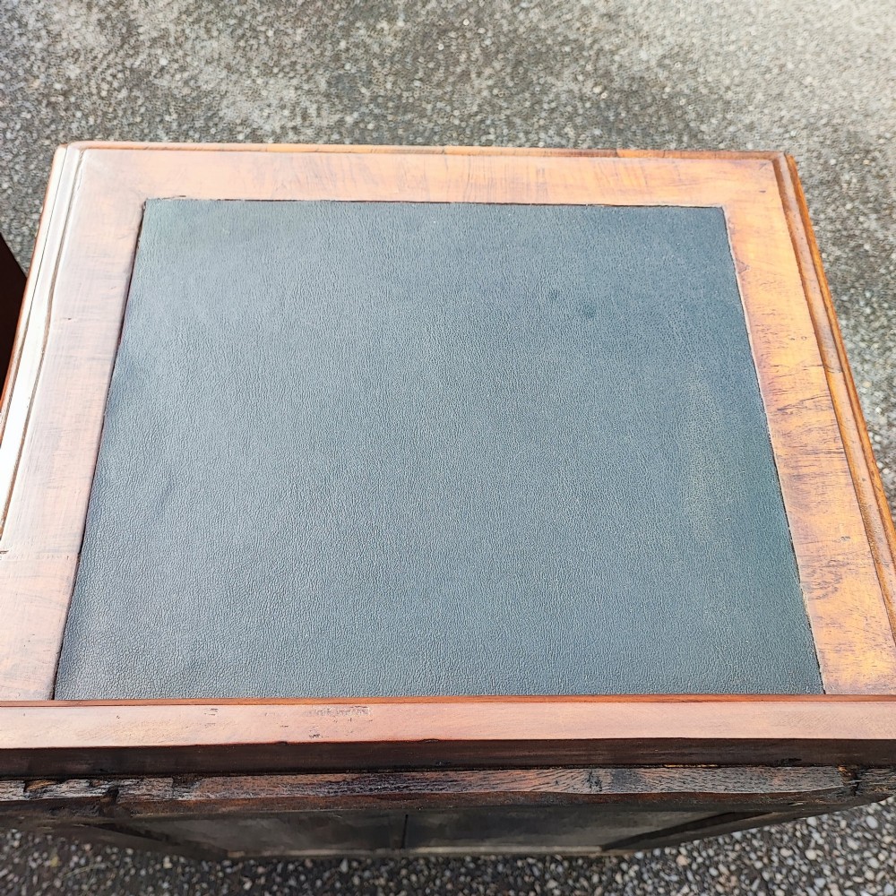 A pair of small warm brown mahogany chests of drawers featuring inset leather tops, four drawers with brass swan-neck handles, and shaped bracket feet. View VII