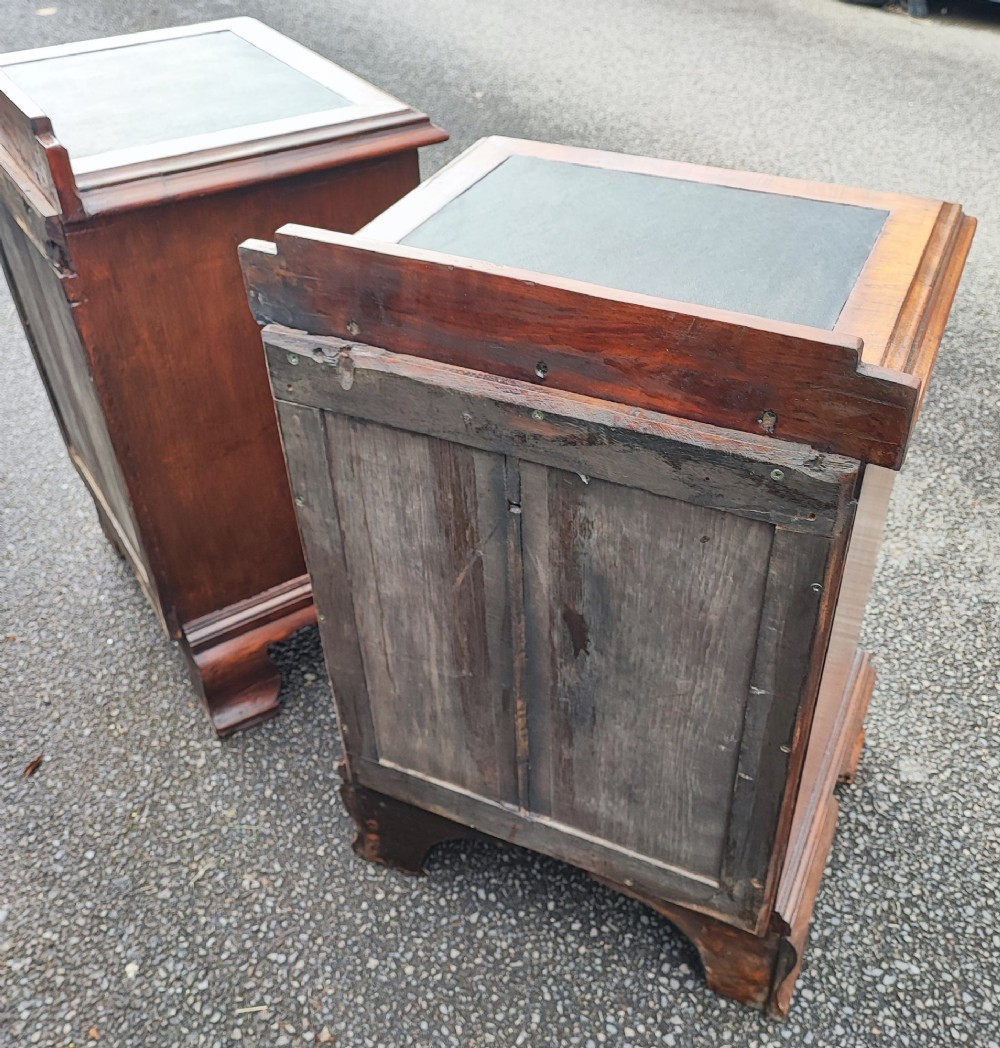 A pair of small warm brown mahogany chests of drawers featuring inset leather tops, four drawers with brass swan-neck handles, and shaped bracket feet. View VIII