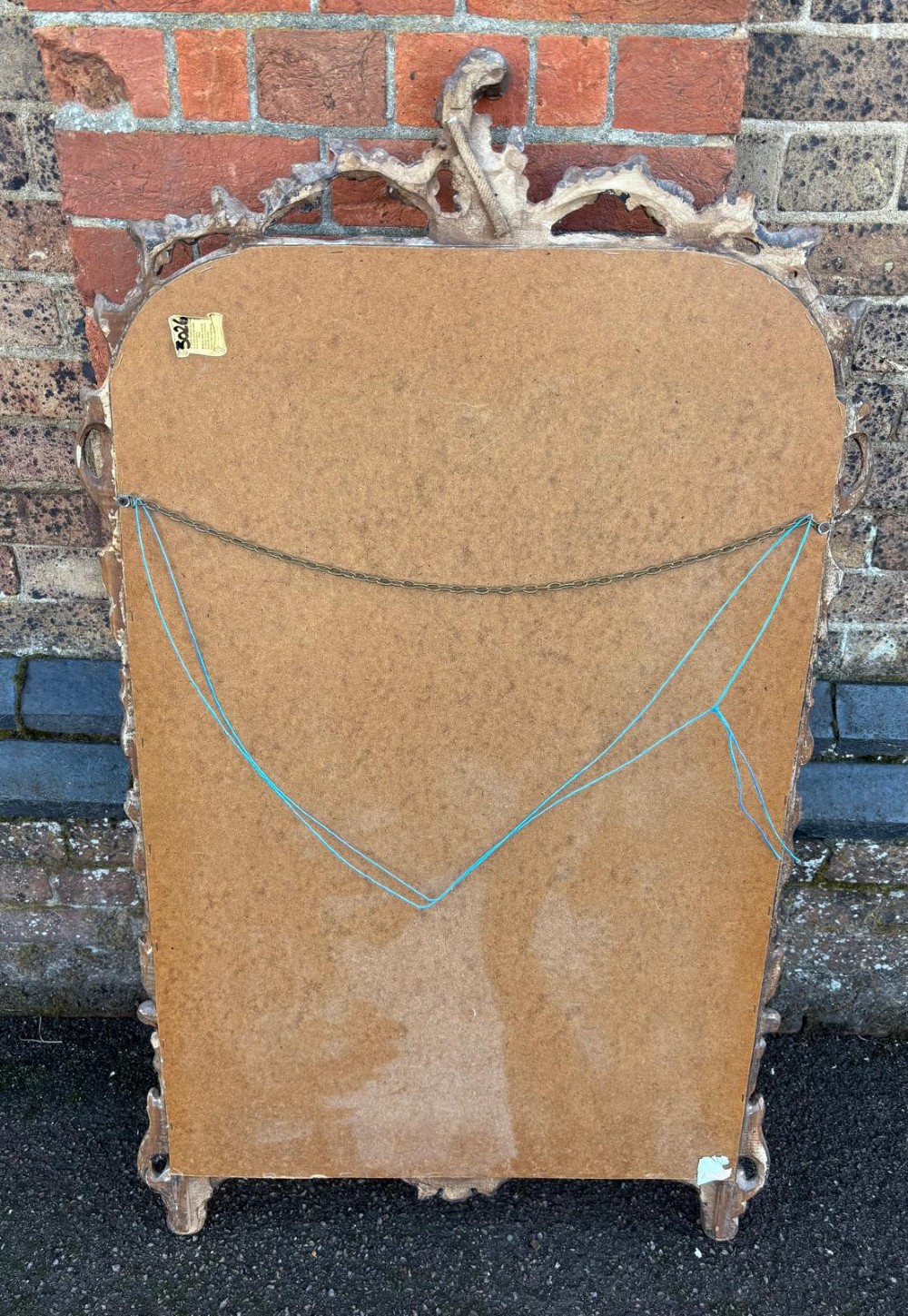 A large 20th-century Italian wall mirror featuring an arched top and an ornate carved wood frame finished in silver and gold leaf with acanthus leaf motifs. View IV