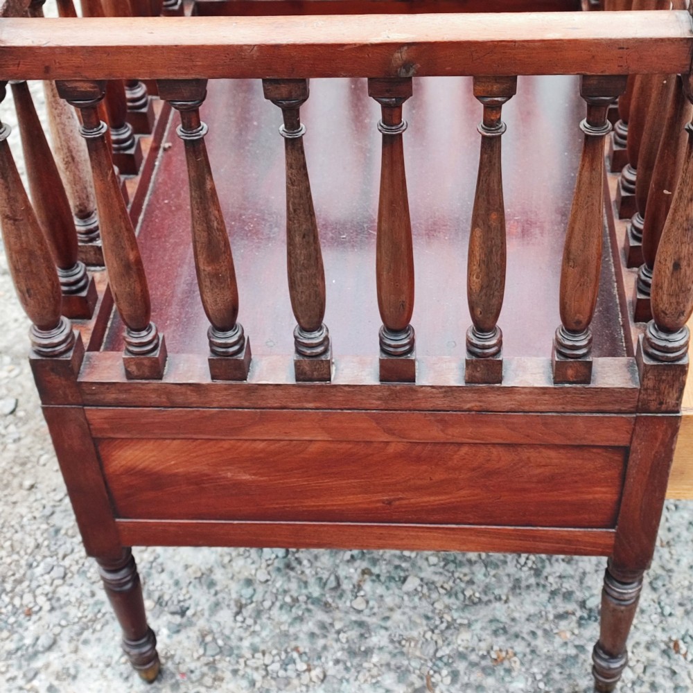 An antique Regency mahogany book trough with turned spindle sides, a single lower drawer with brass handles, and turned legs supported on brass castors. View III