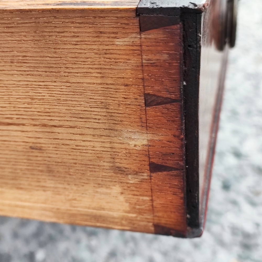 An antique Regency mahogany book trough with turned spindle sides, a single lower drawer with brass handles, and turned legs supported on brass castors. View VI
