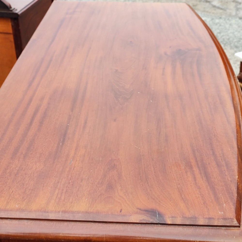 A Victorian mahogany bowfront chest of drawers with two short over three long drawers, turned wooden knobs, and turned feet. View III